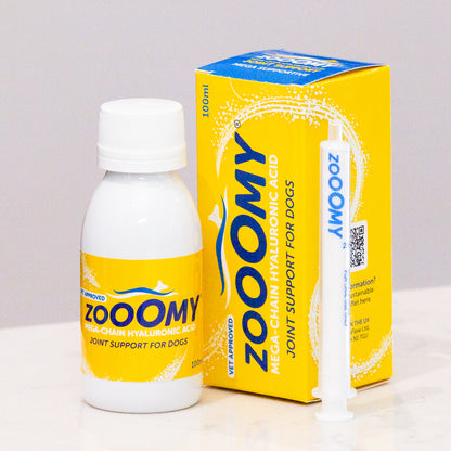 A product image featuring Zooomy Hyaluronic Acid Joint Support for Dogs, including a bottle, a box, and a syringe, all in yellow and white packaging.